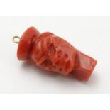 A Victorian carved coral pendant charm formed as a human head 3/4" long Please Note - we do not make