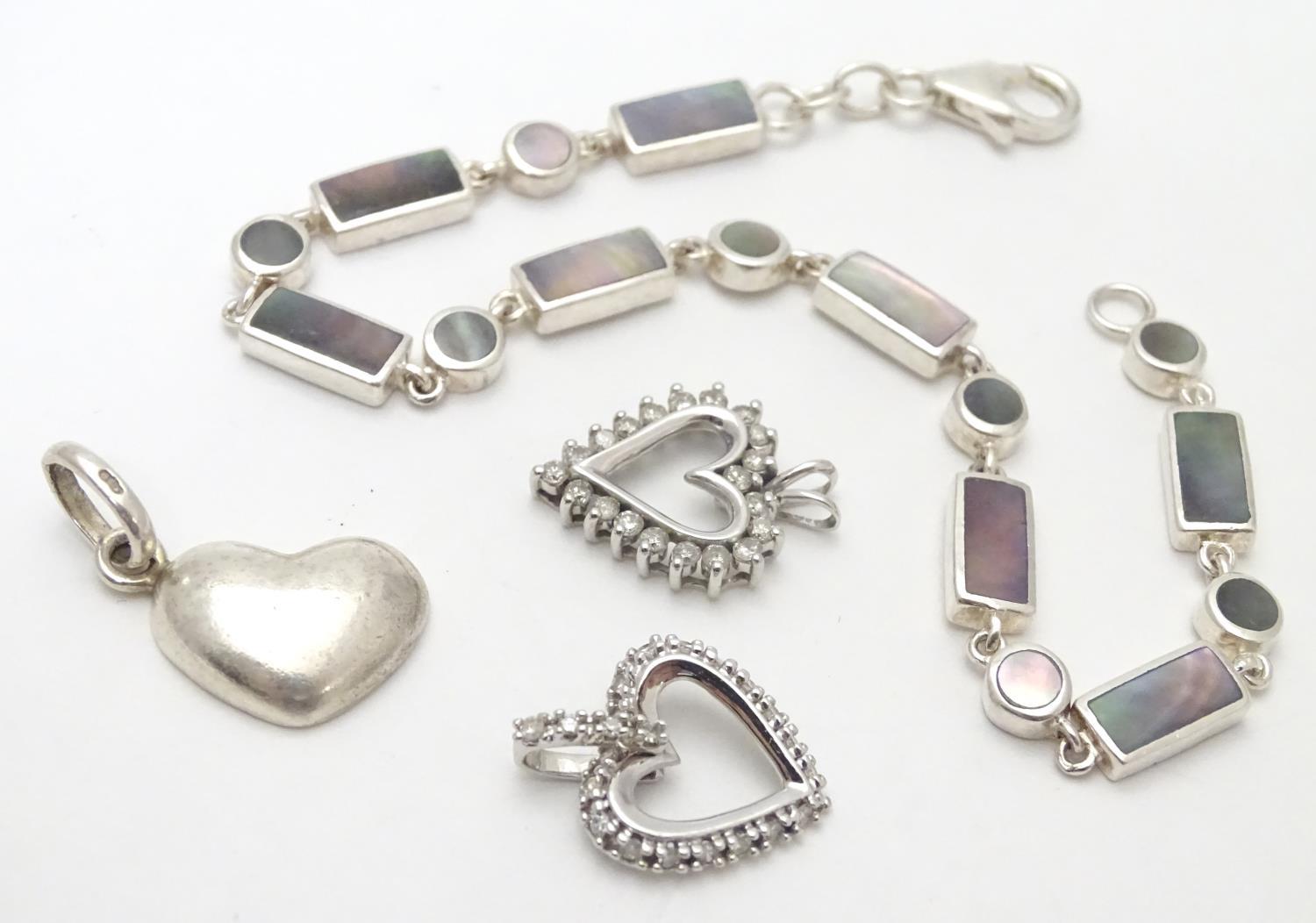 A silver bracelet set with abalone shell detail together with and 3 assorted charms (4) Please - Image 4 of 8