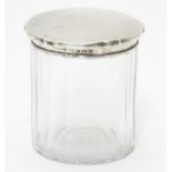 A glass jar with silver lid hallmarked Birmingham 1914 3 1/4" high Please Note - we do not make