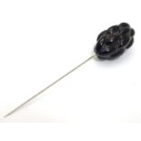 A hat pin set with black jet and white stones. 4 1/2" long overall. Please Note - we do not make