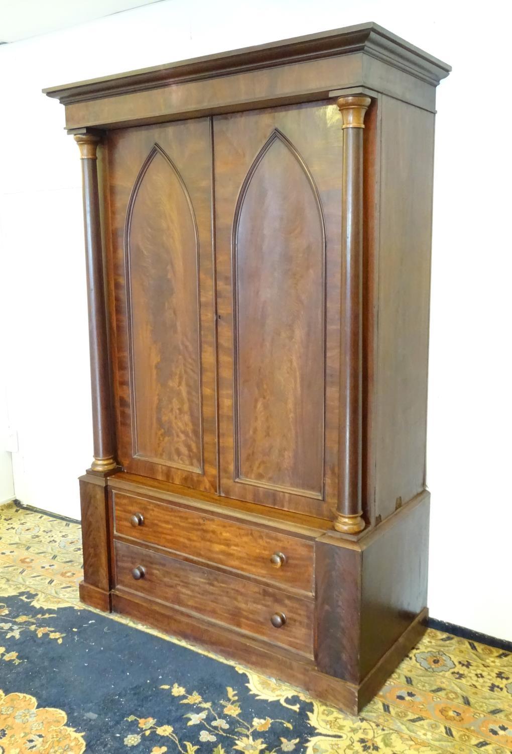 A 19thC mahogany press with a moulded cornice above two large doors with lancet shaped panelling, - Bild 3 aus 7