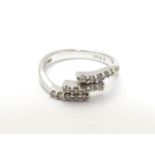 An 18ct white gold ring set with three bands of 5 white stones. Ring size approx H Please Note -