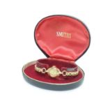 A mid 20thC boxed Smiths ladies' wrist watch, with 9ct gold Dennison case Please Note - we do not