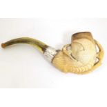 An early 20thC cased carved meerschaum pipe, the bowl formed as an eagle talon, joined to the