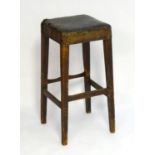 A late 19thC pine stool with a squared top above four tapering legs united by a box stretcher. 16"