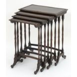 A 19thC mahogany nest of four tables with turned tapering legs and curved stretchers on shaped feet.