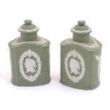 A pair of Wedgwood sage green Jasperware tea caddies and covers, decorated with portrait