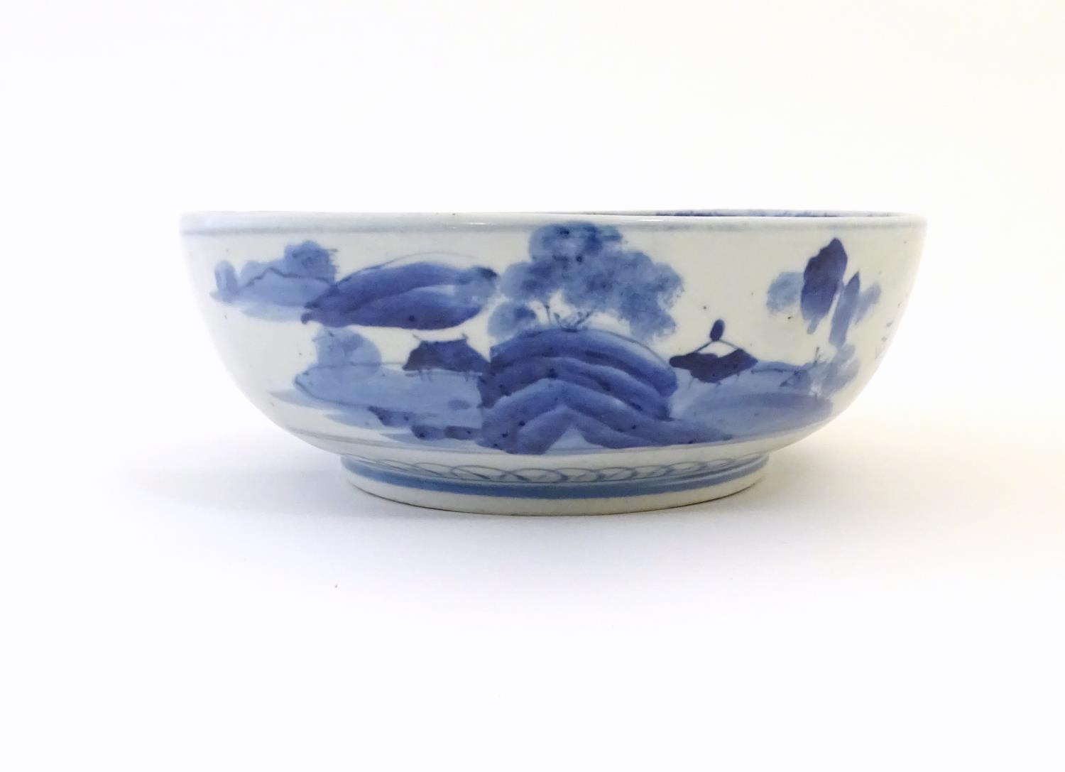 A Chinese blue and white bowl with hand painted decoration depicting an Oriental landscape with - Image 10 of 10
