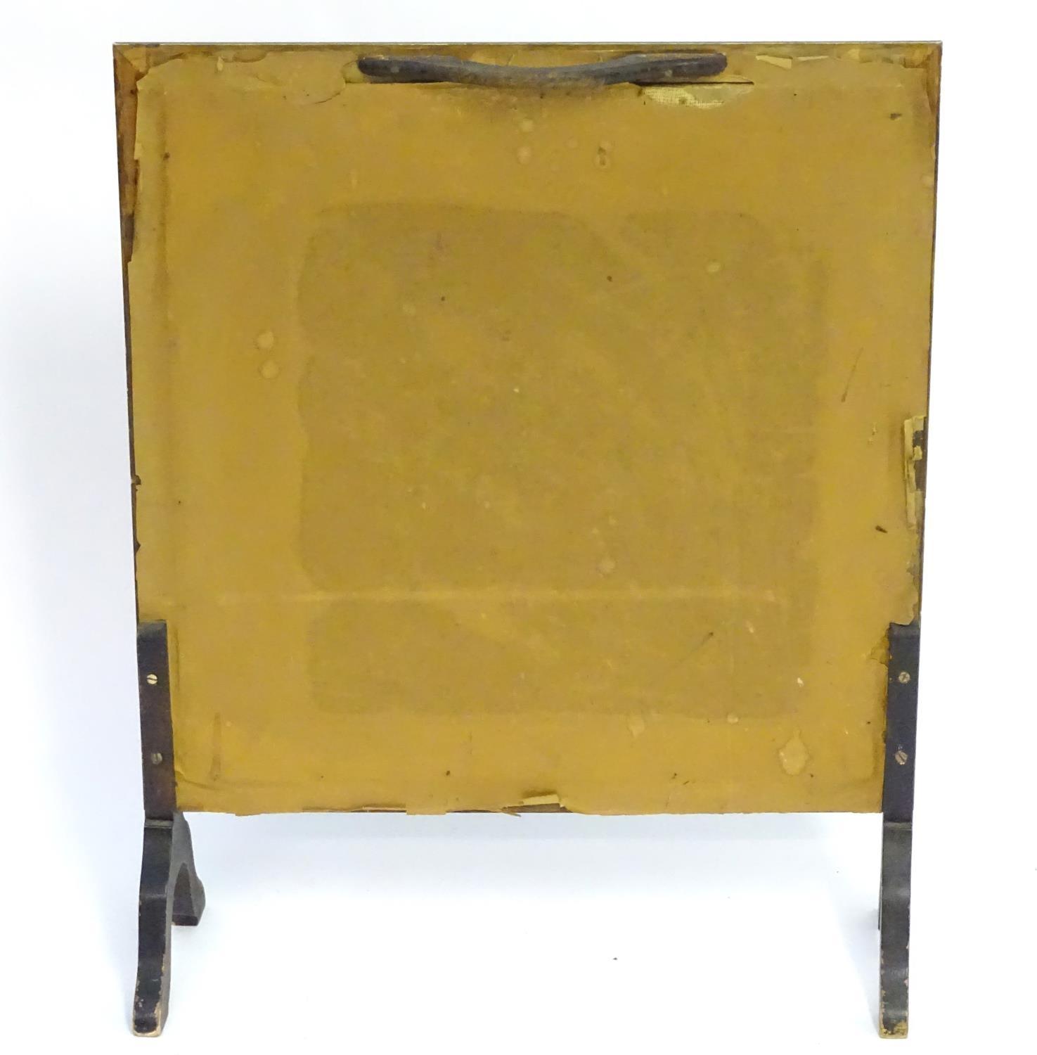 A 20thC fire screen with a moulded surround above a glazed needlework centre. 22" wide x 28" high. - Bild 2 aus 4