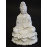A Chinese blanc de chine figure depicting Guanyin seated on a lotus flower base. Approx. 7 1/2" high