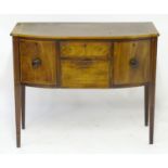 A late 18thC Sheraton style mahogany sideboard with a bowed crossbanded top above an inlaid frame