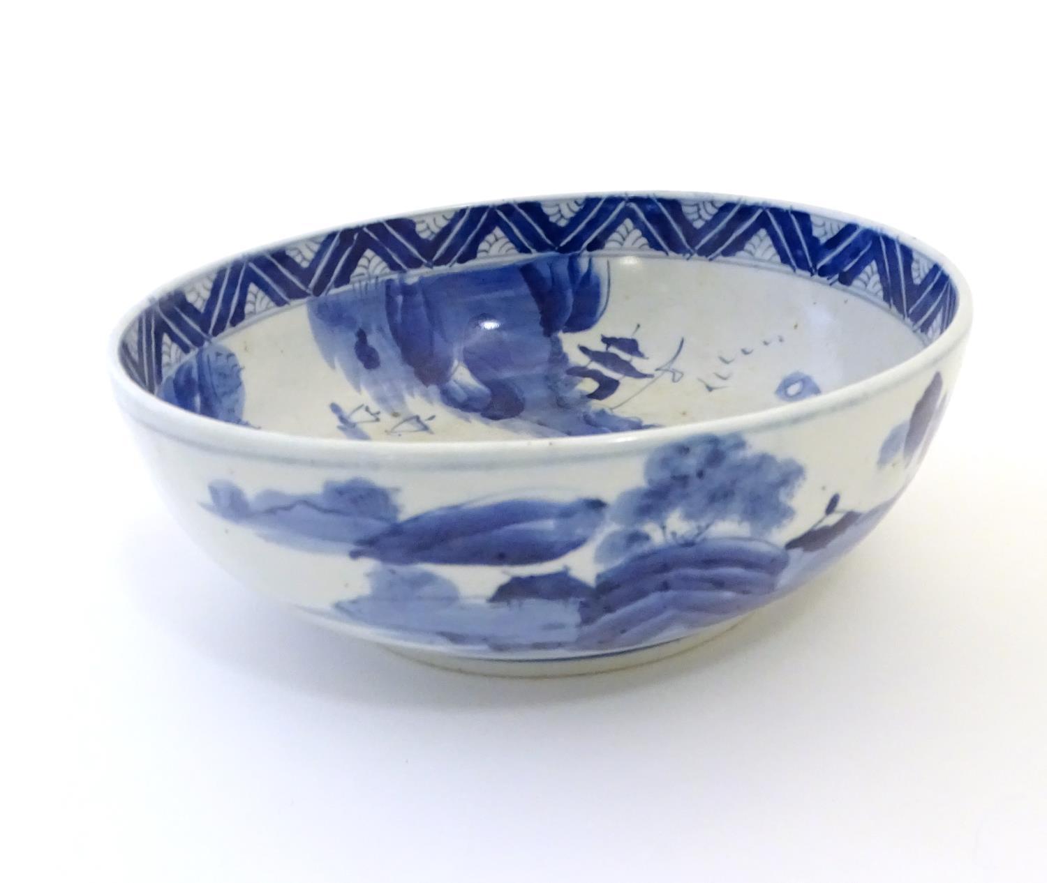A Chinese blue and white bowl with hand painted decoration depicting an Oriental landscape with - Image 7 of 10
