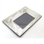 A photograph frame with silver surround with Art Nouveau style decoration. Hallmarked Birmingham