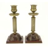 A pair of 19thC Regency brass and tortoiseshell Boulle candlesticks with domed square bases and