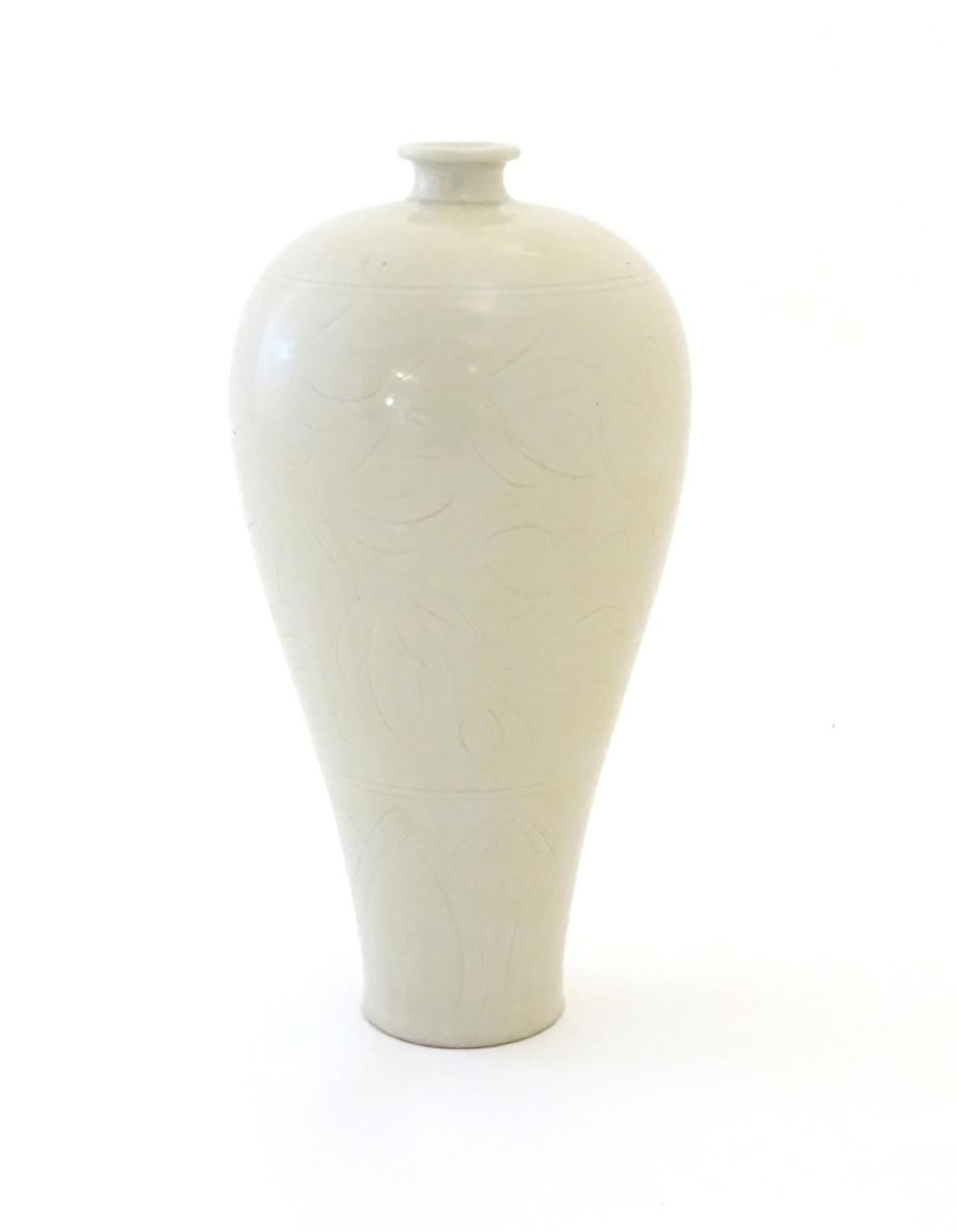 A Korean slender baluster vase with incised stylised floral and foliate detail. Approx. 11 1/2" high
