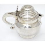 An unusual silver plate jug having hinged lid set with faux Geo III coin and engraved armorial to