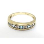 A 9ct gold ring set with topaz and diamond in a linear setting. ring size approx K 1/2 Please Note -