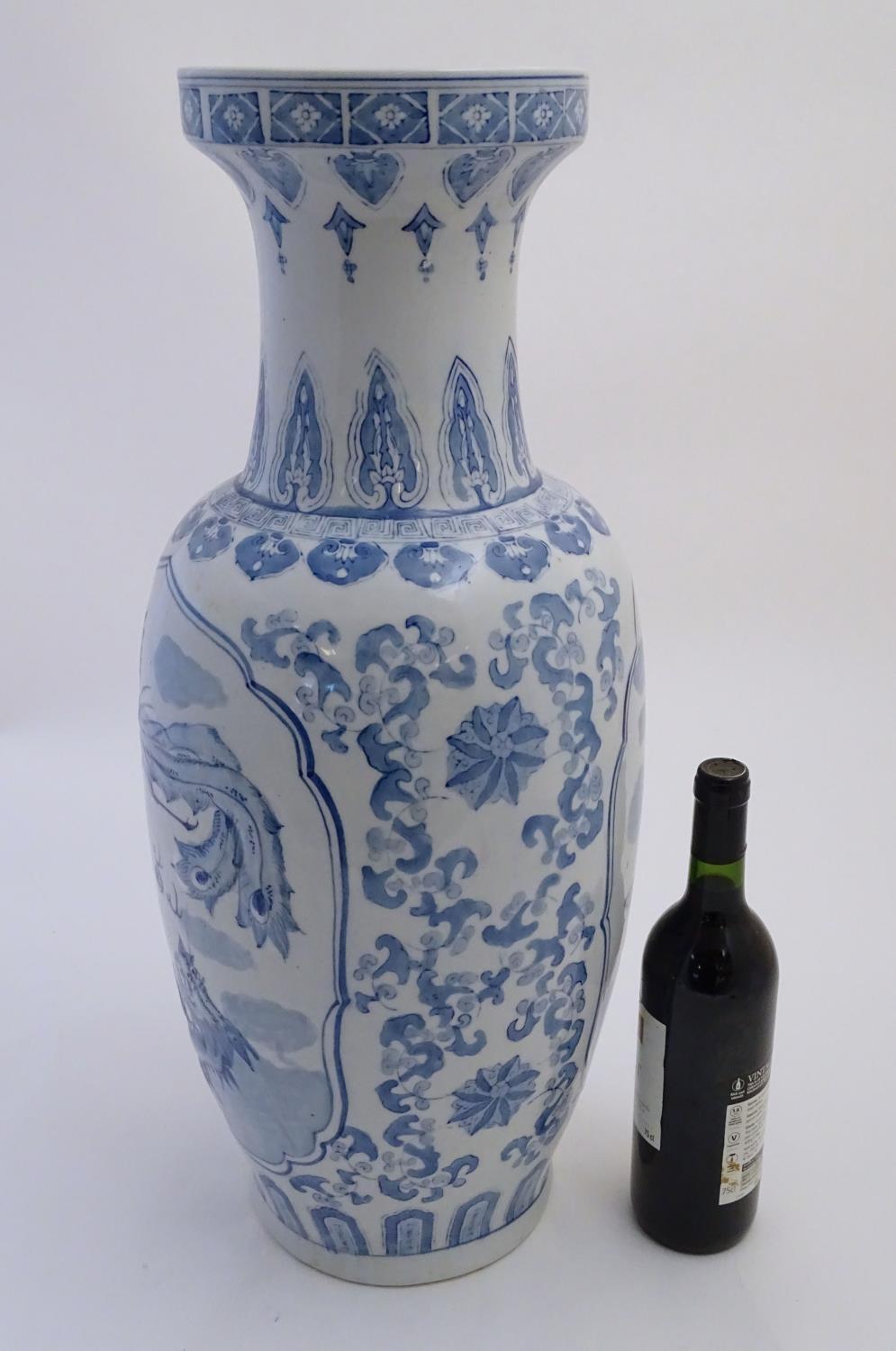 A large Chinese blue and white vase decorated with flowers, foliage and a stylised phoenix and - Image 5 of 10