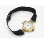 An early 20thC Ladies' wrist watch , with fabric strap and 18ct gold case Please Note - we do not