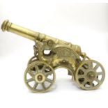 A 20thC brass desk / ornamental cannon, the chassis formed as dragons, 18" long overall Please