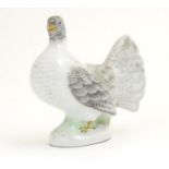 A porcelain model of a fantail pigeon. Approx. 4" high Please Note - we do not make reference to the