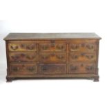 An 18thC oak mule chest with a lifting lid above three short drawers to the base, all the drawer