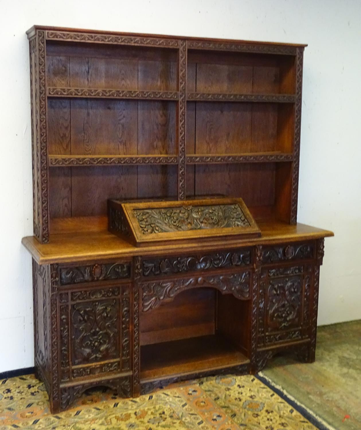 An early 20thC dresser with a blind fretwork carved plate rack above a carved slope and three - Bild 4 aus 5