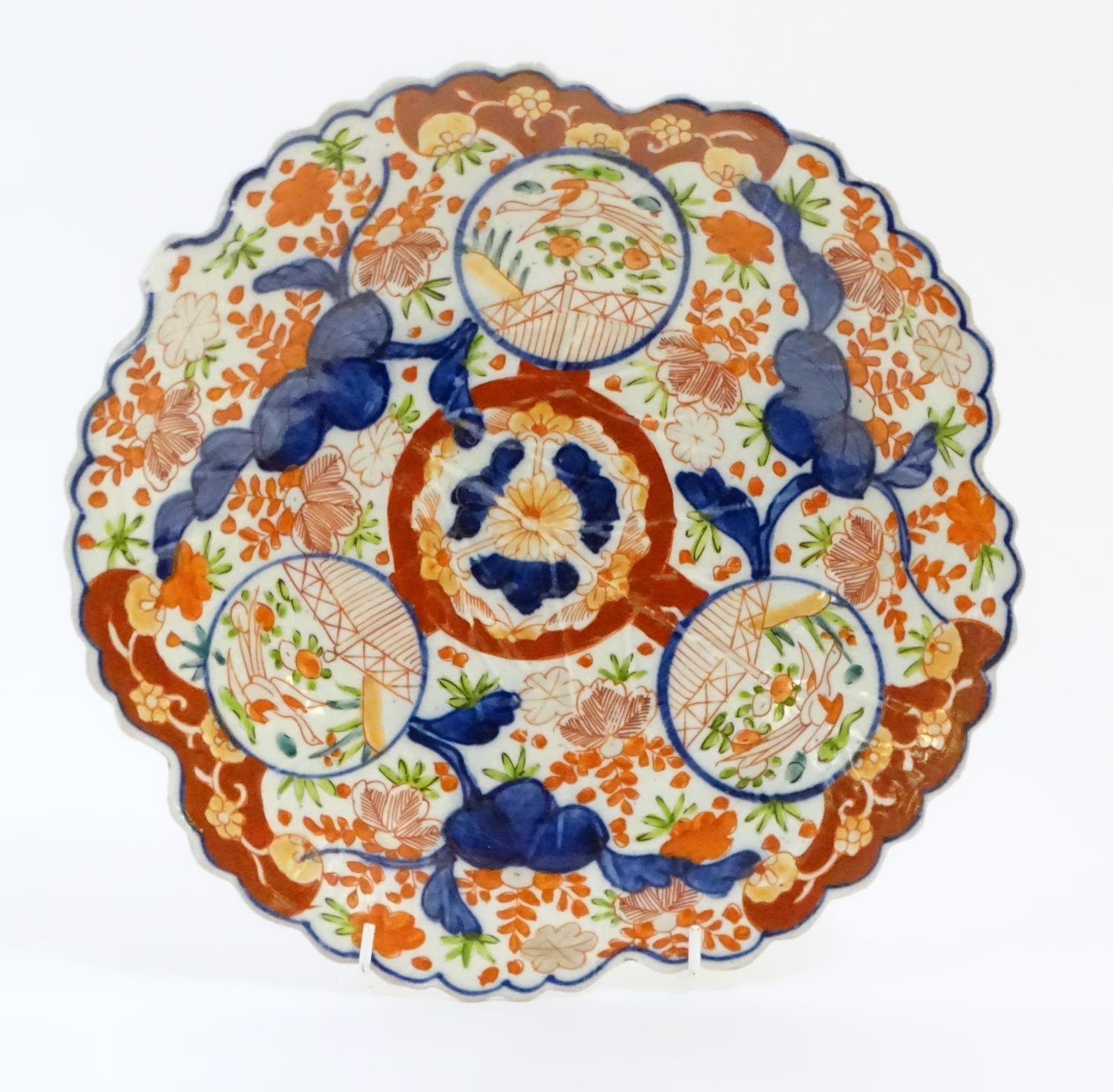 A Japanese Imari plate with a scalloped rim with stylised leaf veins in relief to the centre, - Image 2 of 9