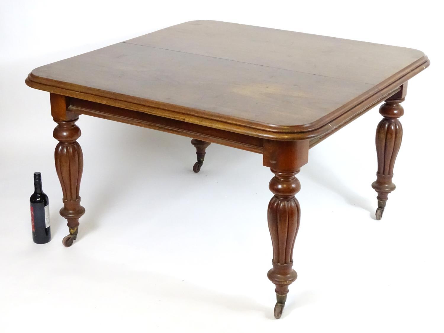 A mid / late 19thC mahogany extending dining table with a moulded top above reeded baluster legs - Bild 6 aus 6