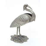 A white metal model of a stork / crane. indistinctly marked under. Approx. 4 1/2" high Please Note -
