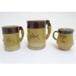 Three Denby two tone stoneware tankards / mugs, two with relief hunting scenes and handles formed as