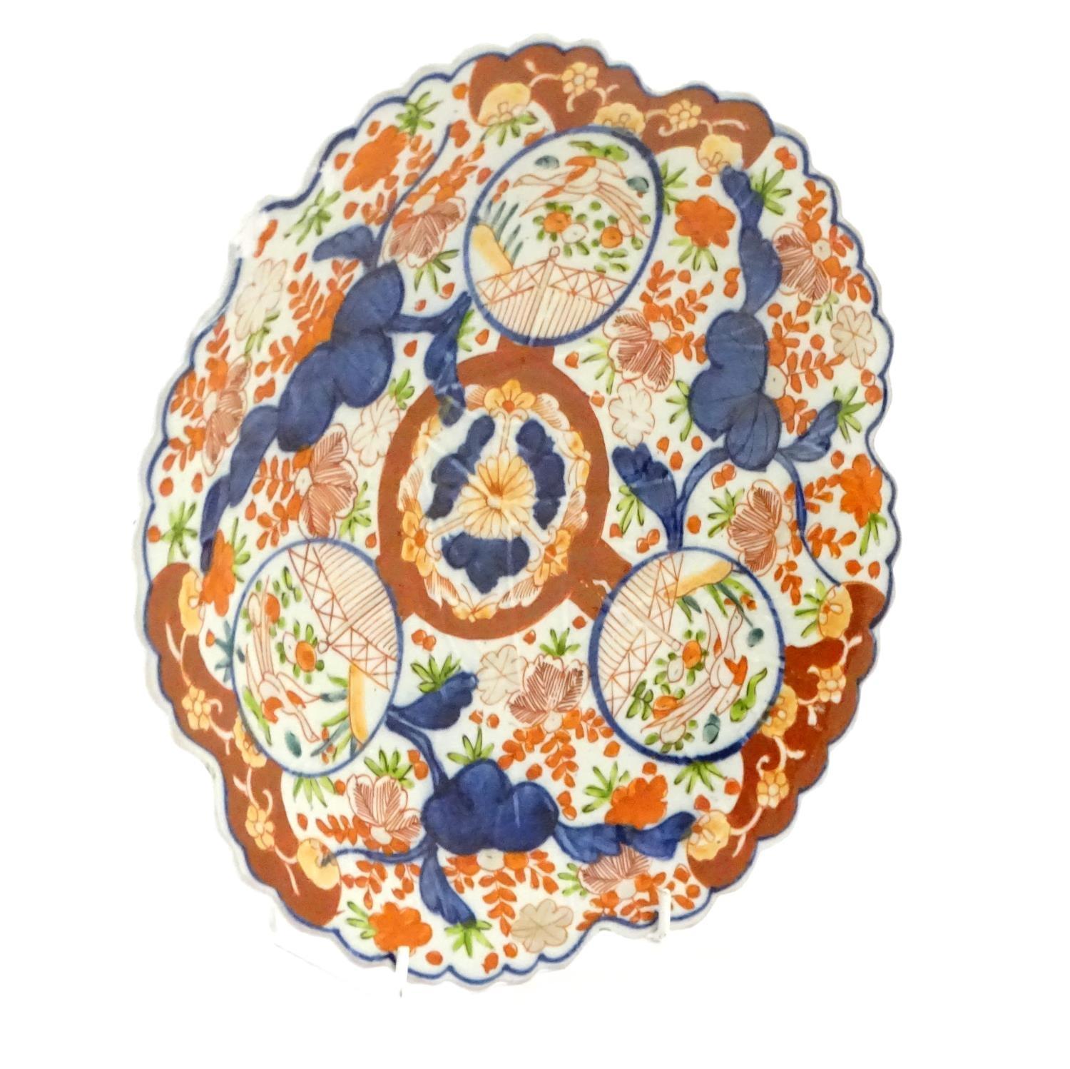 A Japanese Imari plate with a scalloped rim with stylised leaf veins in relief to the centre, - Image 4 of 9