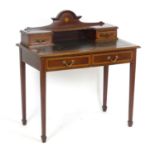 An early 20thC ladies writing desk with marquetry decoration, crossbanded drawers and decorative