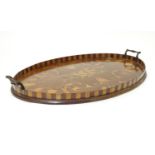 An Edwardian oval tray with parquetry gallery, twin handles and central inlay depicting musical