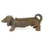 A late 20thC cast iron boot scraper modelled as a dachshund / sausage dog. Approx. 14 1/2" long