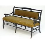 A late 19thC Aesthetic movement ebonised sofa in the manner of E.W Godwin. The sofa having a