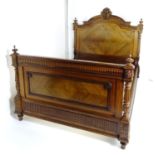 A late 19thC rosewood double bed with a carved shaped headboard mounted by turned finials and having