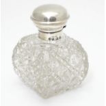 A cut glass scent / perfume bottle with silver top hallmarked Birmingham, 1930 maker William