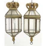Two late 19thC / early 20thC gilt metal pendant lights of octagonal lantern form with crowns