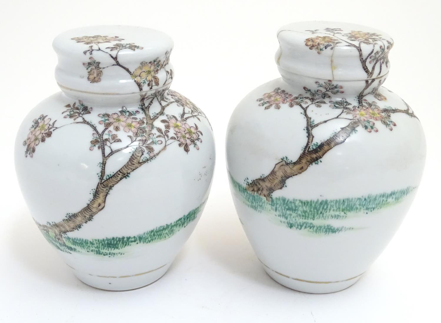 A pair of Oriental spice jars with lids and covers with hand painted decoration depicting two female - Image 3 of 9