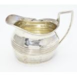 A Victorian silver cream jug hallmarked Birmingham 1893. Approx 3" high Please Note - we do not make