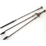 A pair of 19thC Gothic Revival wrought iron fire tools, comprising tongs and poker, each having