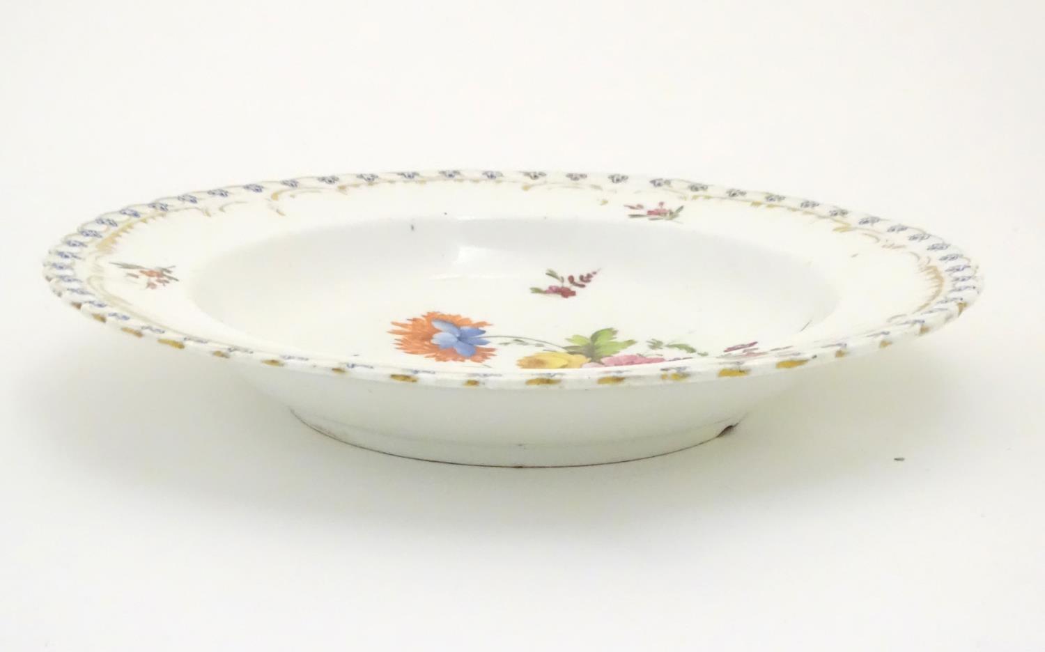 A 19thC porcelain soup dish with hand painted flower detail and gilt highlights. Approx. 10" - Image 3 of 3