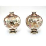 A pair of Japanese Satsuma vases of globular form in the Kutani style with flared rims and feet. The