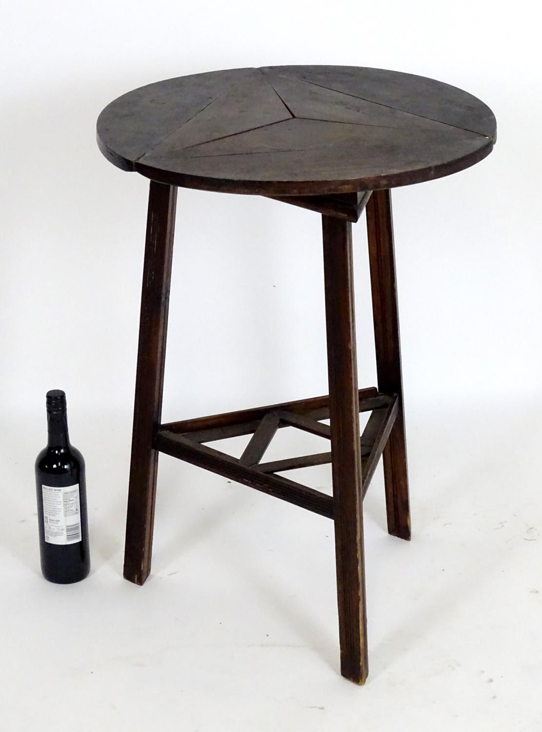 An early 20thC country made cricket table with a folding rotating top and raised on three squared - Bild 5 aus 5