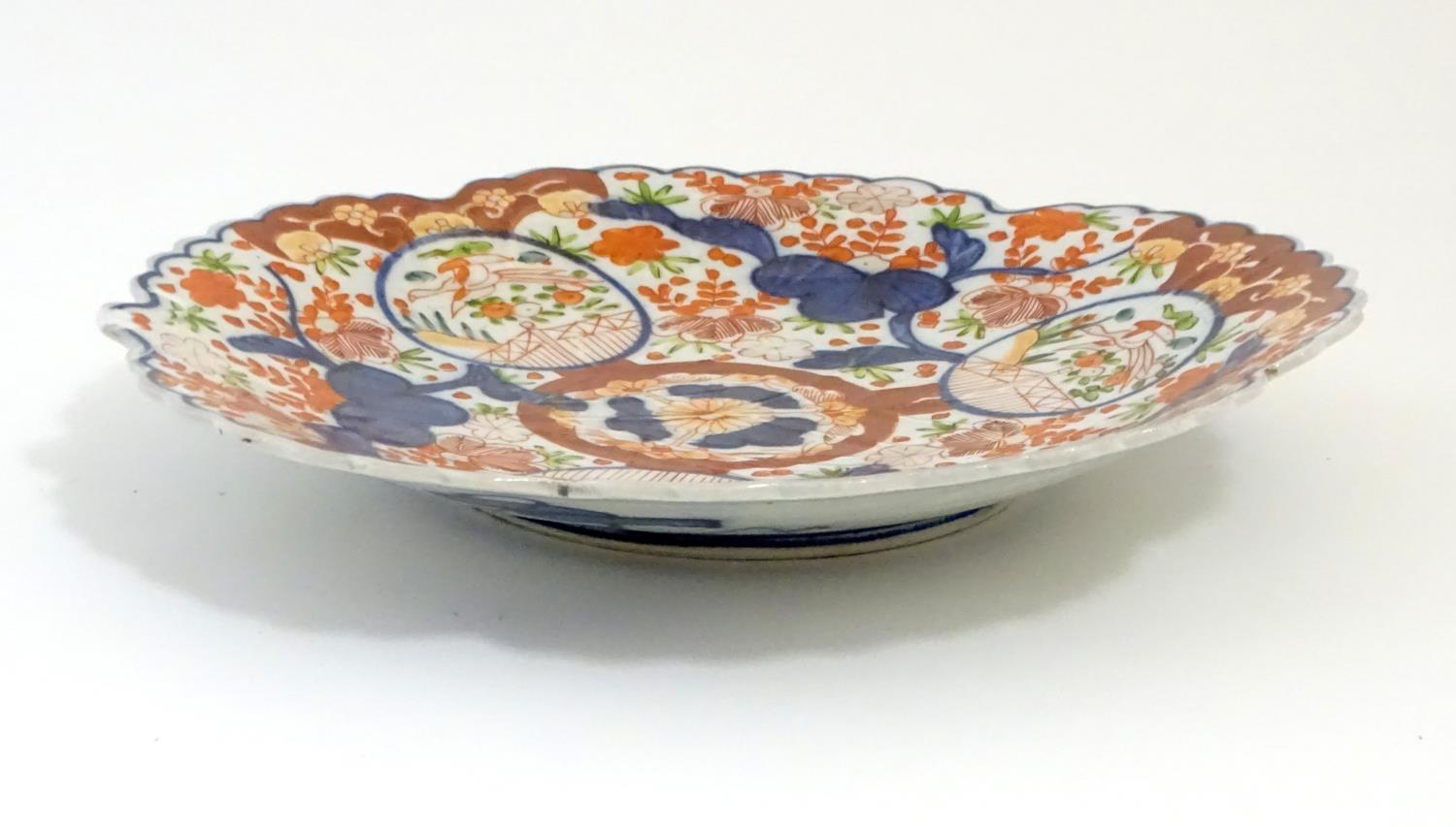 A Japanese Imari plate with a scalloped rim with stylised leaf veins in relief to the centre, - Image 5 of 9