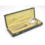 A Continental Art Deco silver plate ladle. Approx 9" long. cased Please Note - we do not make