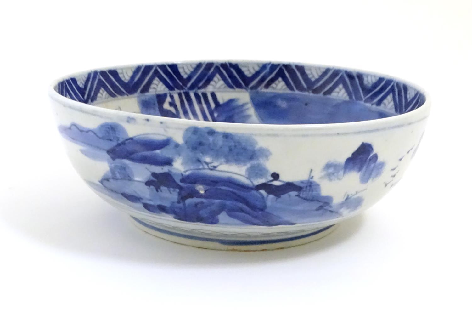 A Chinese blue and white bowl with hand painted decoration depicting an Oriental landscape with - Image 2 of 10