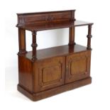 A mid 19thC mahogany buffet with a shaped upstand above two turned fluted supports and panelled