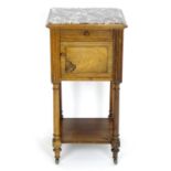 A late 19thC rosewood bedside cabinet with a marble inset top, single short drawer and cupboard